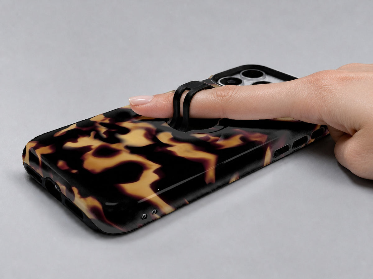 Tortoiseshell MagSafe Loop iPhone Case shown in use with a finger through the horizontal loop