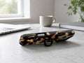 Tortoiseshell MagSafe Loop iPhone Case shown in a neutral white professional lifestyle setting