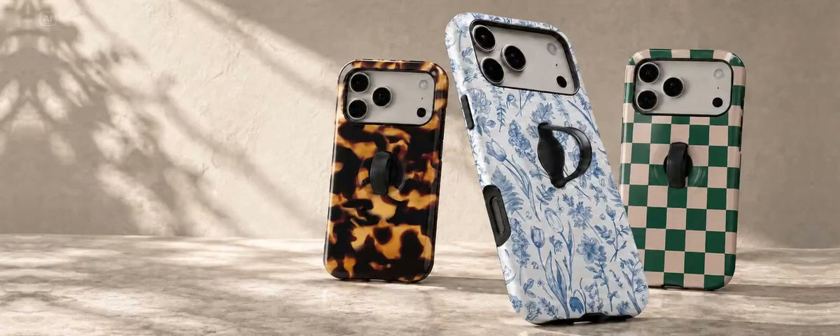 Three Loop cases in blue botanical, tortoiseshell and green checkerboard prints, styled in warm natural light.