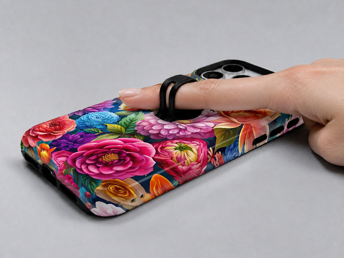 Vibrant Garden Floral Bouquet MagSafe Loop iPhone Case shown in use with a finger through the horizontal loop