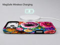 Vibrant Garden Floral Bouquet MagSafe Loop iPhone Case shown with a MagSafe-compatible wireless charger attached