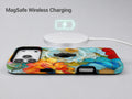 Vibrant Poppy Stained Glass MagSafe Loop iPhone Case shown with a MagSafe-compatible wireless charger attached