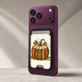 Vintage Book Pumpkin MagSafe Card Holder, attached to a compatible phone