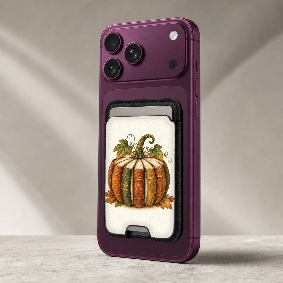 Vintage Book Pumpkin MagSafe Card Holder, attached to a compatible phone