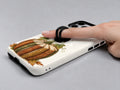 Vintage Book Pumpkin MagSafe Loop Case, shown with a finger through the loop