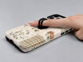Vintage Botanical Collage MagSafe Loop iPhone Case shown in use with a finger through the horizontal loop