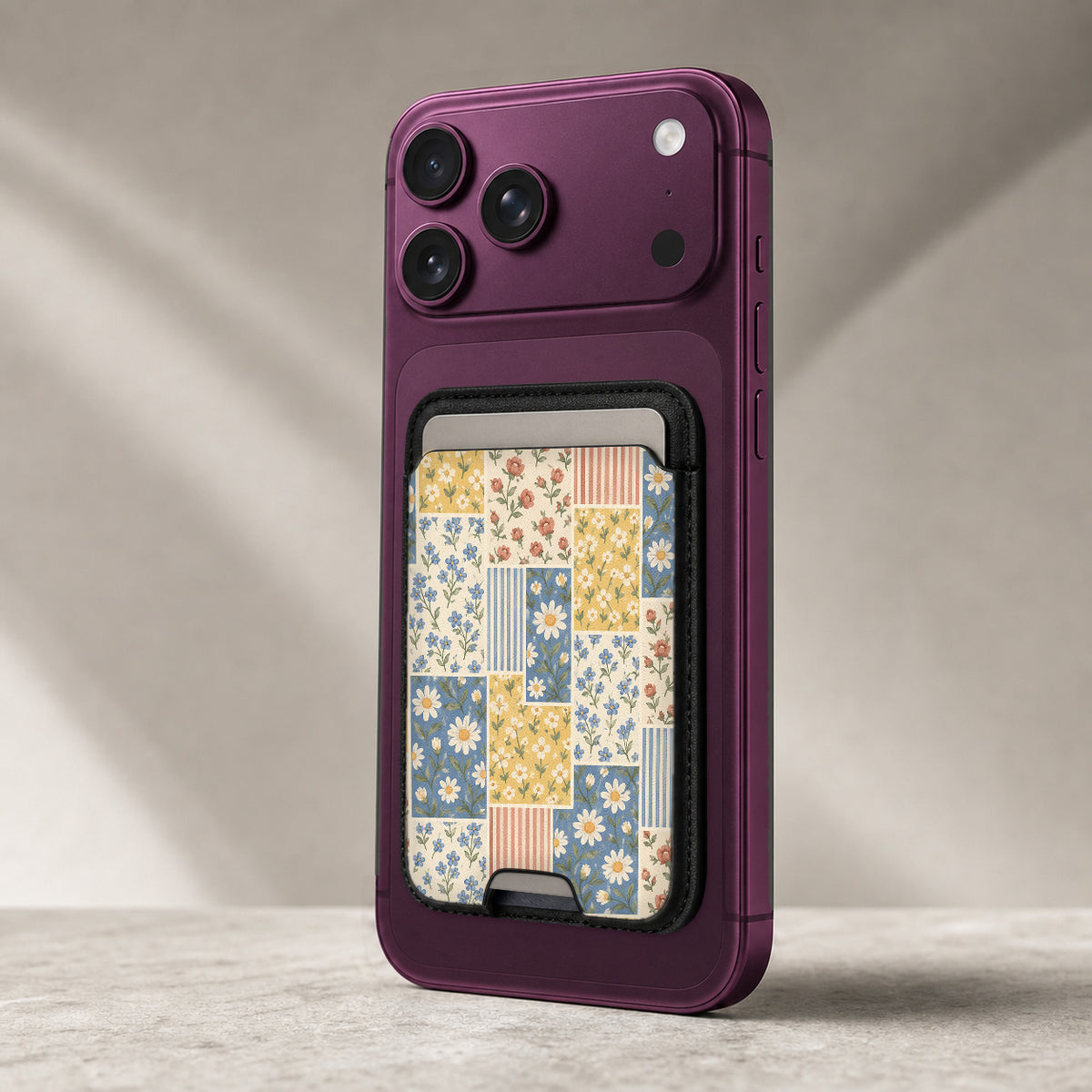 Blue and Yellow Daisy Floral Patchwork MagSafe Card Holder, attached to a compatible phone