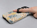 Blue and Yellow Daisy Floral Patchwork MagSafe Loop Case, shown with a finger through the loop