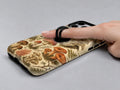 Vintage Mushroom Botanical MagSafe Loop iPhone Case shown in use with a finger through the horizontal loop