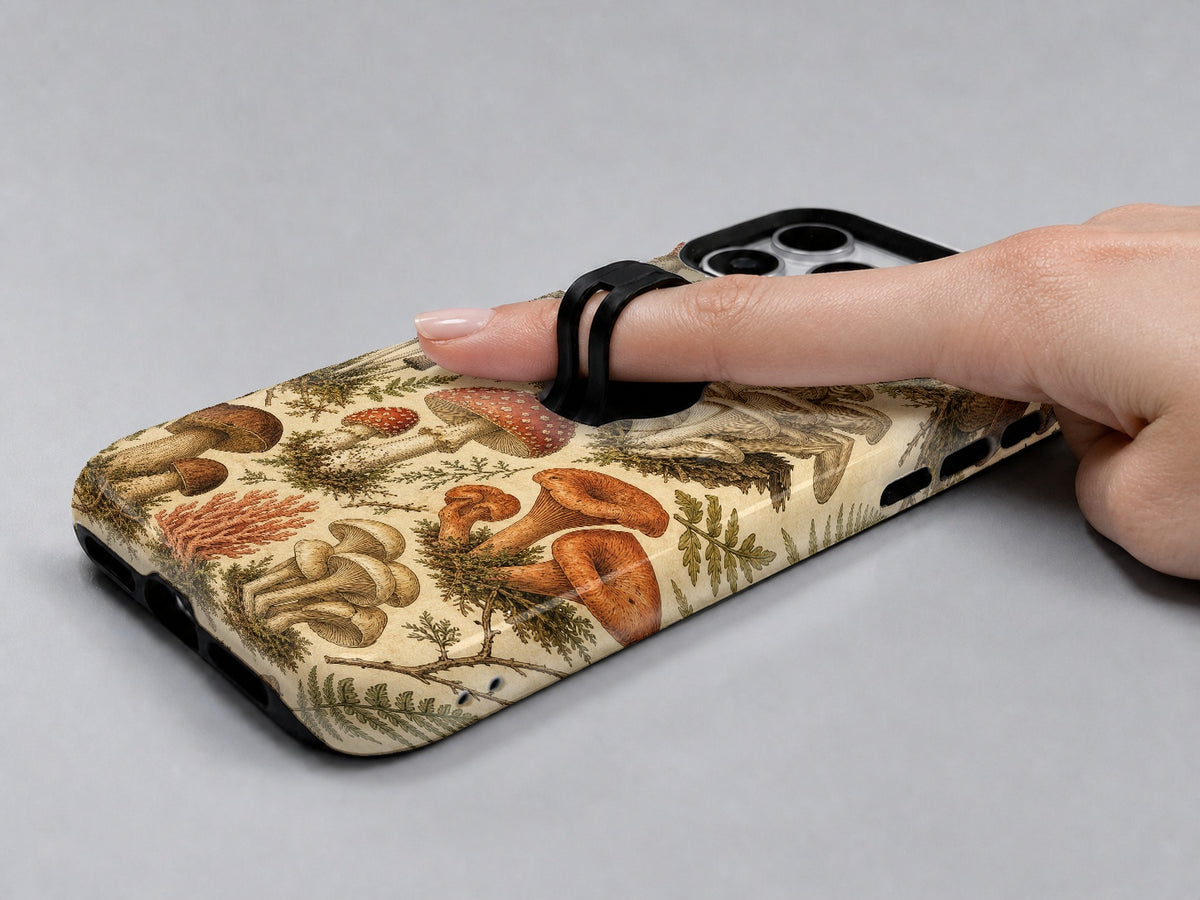 Vintage Mushroom Botanical MagSafe Loop iPhone Case shown in use with a finger through the horizontal loop