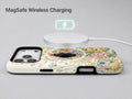Vintage Wildflower Meadow MagSafe Loop iPhone Case shown with a MagSafe-compatible wireless charger attached