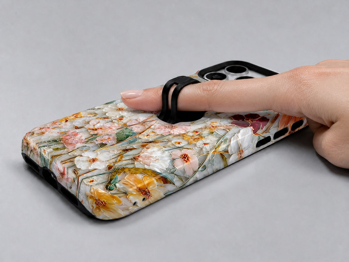 Warm Wildflower Stained Glass MagSafe Loop iPhone Case shown in use with a finger through the horizontal loop