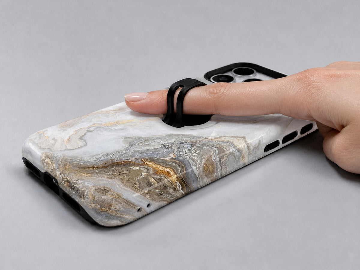 White Gold Marble MagSafe Loop iPhone Case shown in use with a finger through the horizontal loop